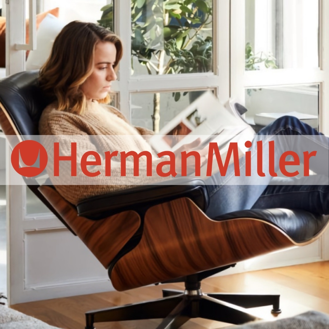 A person sitting in a chair reading a bookDescription automatically generated with medium confidence